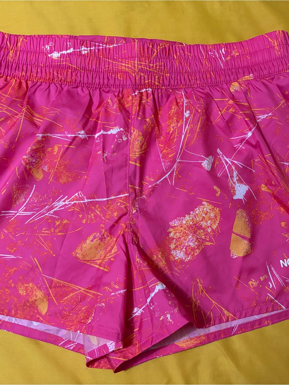 The North Face Pink Athletic Shorts with Orange & White Print